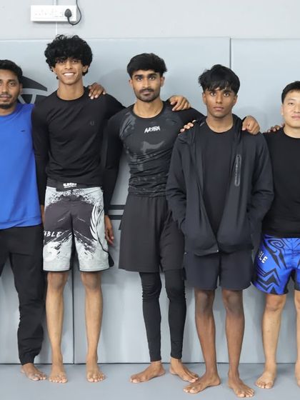 One of the talented teams that competed in our annual in-house Jiu-Jitsu tournament, standing proud with their coach.