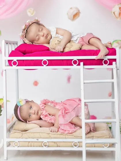 Double the giggles, double the love! This creative bunk bed prop is so much fun for twin photoshoots, telling a story of their shared childhood.