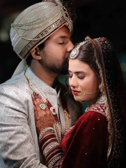 A tender moment. The makeup is designed to last through all the emotional moments of a wedding day.