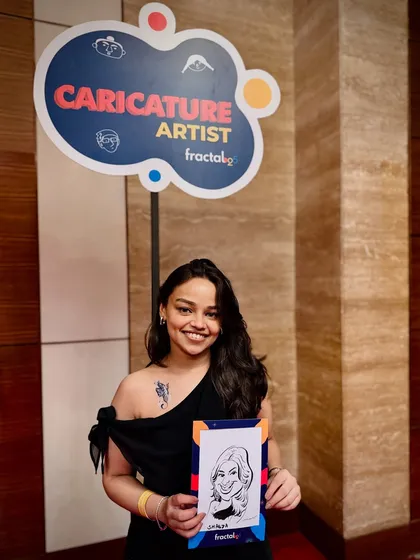 A happy guest at a corporate event for Fractal25 holding her personalized souvenir. My aim is to give every person a piece of art that not only makes them laugh but also serves as a wonderful memory of the day.