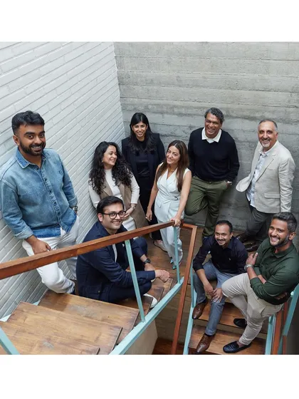 Another shot from the Khosla Associates studio reunion, capturing the warmth and easy camaraderie of the group on the studio's iconic staircase.