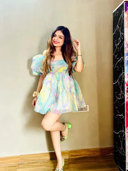 Bringing the Barbie era to life with this dreamy pastel organza dress. The puffy off-shoulder sleeves and floral print make it a super cute and playful outfit for a summer day out or a brunch date.