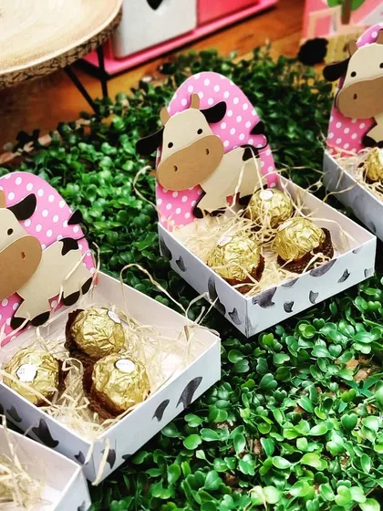 Even the party favors are part of the theme. These adorable cow-themed boxes filled with chocolates are a sweet way for guests to take a piece of the barnyard fun home with them.