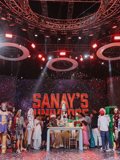 The grand finale of 'Sanay's Universe', with the birthday boy and his family surrounded by characters from every themed zone. This shot captures the epic scale and excitement of the event.