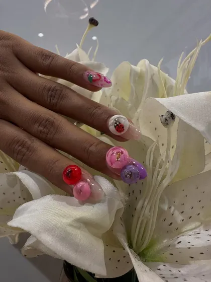 Go beyond flat color with our playful 3D nail embellishments. This set features individually sculpted acrylic fruits and flowers, including tiny ladybugs and glossy cherries, creating a fun, textured look that’s full of personality. It’s a perfect example of how we can make your nail art truly pop.