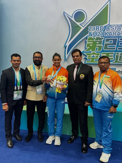 The official KIO delegation with silver medalist Ms. Rusha Tambat in China. We provide a complete support system for our athletes at international events.