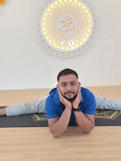 A relaxed practitioner in a full center split (Samakonasana), showing the results of consistent flexibility training.