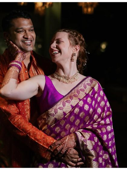 Pure joy and love. This candid moment captures the happiness of the couple during their Mehendi ceremony, with the bride wearing the meaningful heirloom saree.