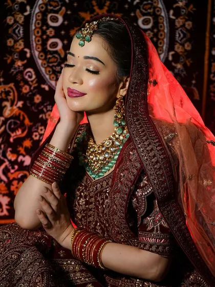 A serene, eyes-closed shot that highlights the flawless base and the beautiful blend of colors in this vintage-style bridal look.