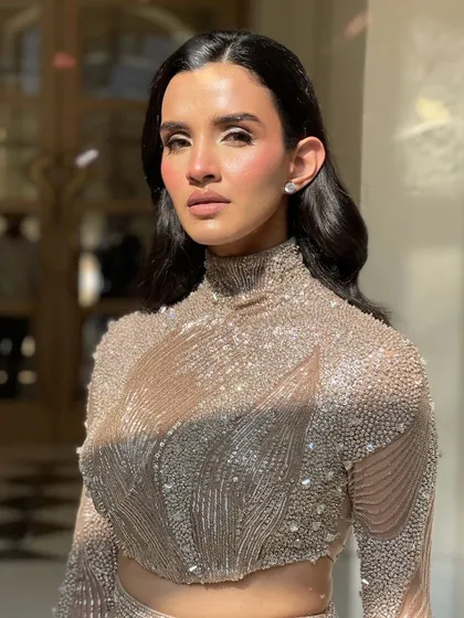 A confident portrait of the model. The sleek, structured waves give her a powerful and sophisticated look.