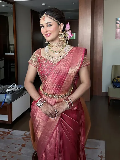 The full look of this beautiful South Indian bride. The makeup, hair, and saree drape all come together to create a look of pure elegance.
