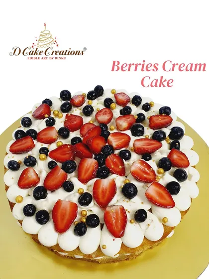 A light and airy berries and cream cake, topped with a generous amount of fresh strawberries and blueberries.