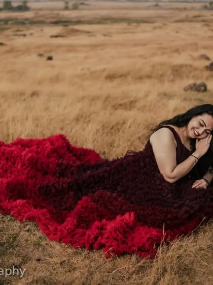 A candid and joyful moment from the same pre-wedding session. She is resting her head on his lap and smiling, capturing the comfortable and happy love they share.
