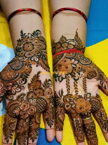 A beautiful pair of hands with a fusion of Arabic and traditional Indian mehandi. The designs are different but complement each other perfectly.