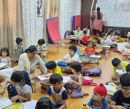 Another view of our bustling classroom. We use a mix of floor seating and low tables to create a comfortable and flexible learning space.