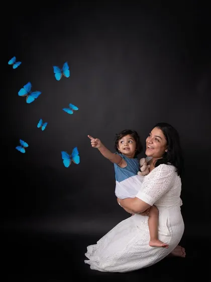 There's nothing more special than the bond between a mother and her child. I always encourage parents to jump into the photos. In this mommy-and-me portrait, we added a touch of magic with these blue butterflies to create a dreamy, unforgettable image.