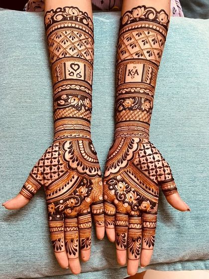 A classic engagement design with the couple's initials, 'K' and 'A', and a heart symbol. The geometric patterns and floral borders give it a modern yet traditional feel.