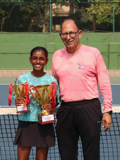 Trisha Bhosale with a tournament official and her two winner's trophies from the U-12 Championship Series.