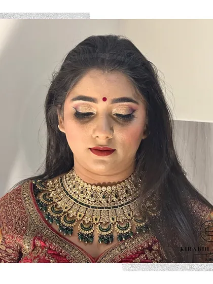 A close-up on the bride's makeup, showing a soft glam eye with a hint of shimmer and a perfectly matched lip color. I focus on creating a flawless base that looks like second skin.
