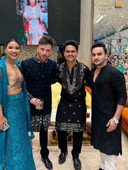 Wedding guests dressed in our coordinated black ethnic wear. Each kurta has a different embroidery pattern and cut, from a simple textured design to a more elaborate embellished piece.