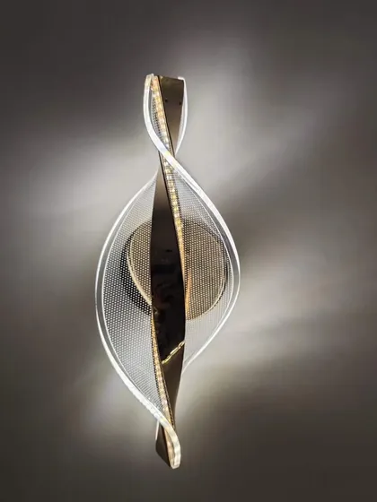 A sculptural wall light with a twisting metal and acrylic design. This fixture is a piece of art that adds a modern, dynamic touch.