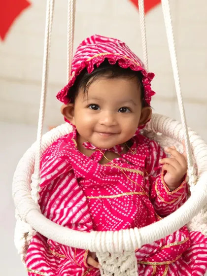 A close-up of a sweet, smiling face. The Raja Parba sessions are designed to be bright, happy, and full of traditional charm.