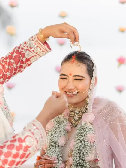 The sindoor ceremony, a moment of deep significance and gentle intimacy. The bride's blissful smile as the groom applies the sindoor is a beautiful sight.
