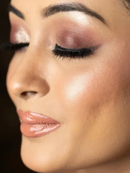 A detailed close-up of the eye makeup from one of our masterclass looks. This shot emphasizes the glossy lid, the sharp liner, and the perfectly groomed brow.