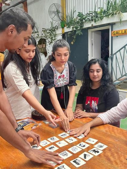 A group of participants deeply engaged in a strategy board game during one of our game nights. These events are a great way to connect with new people and exercise your mind.