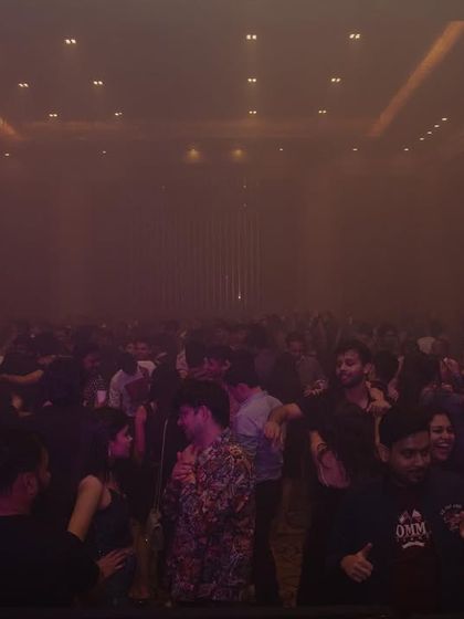 A packed room at our New Year's Eve bash, filled with atmospheric smoke. I use effects to build a sense of anticipation and excitement throughout the night.
