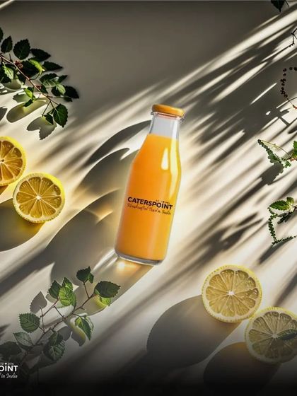 Sip, relax, and repeat. This beautifully styled shot of our fresh juice, surrounded by lemons and greenery, is perfect for unwinding on a hot day.