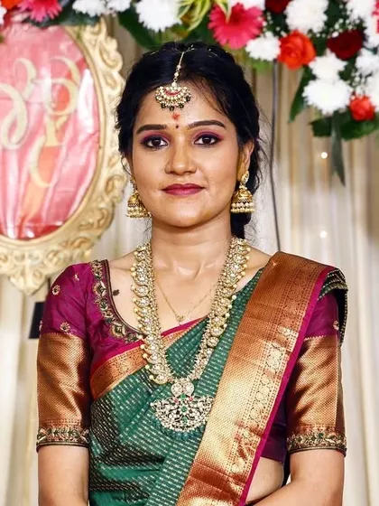 A close-up of Deepika's engagement makeup. The purple and pink eyeshadow matches her blouse, and the skin is flawless.
