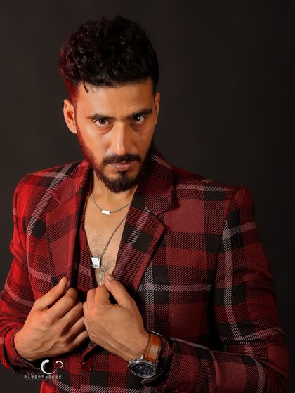 A close-up, intense portrait that feels like a frame from a movie. The focus is on his direct gaze and the story it tells.