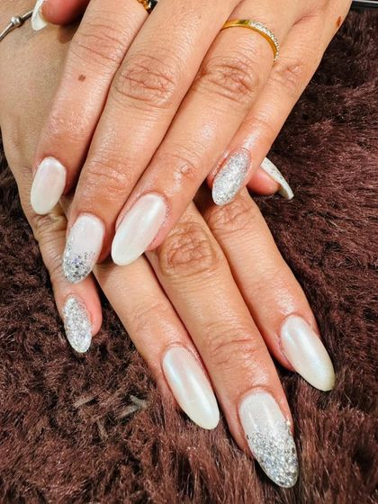 A classic wintery look with pearly white nails and a silver glitter fade on the accent nails.