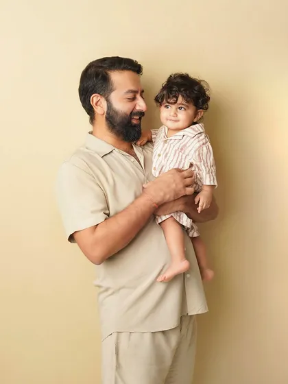 A father holds his son, and they share a look of mutual adoration. These are the quiet, meaningful moments I strive to capture.