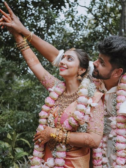 A joyful moment between Bhagya and Prabhu after their ceremony. Their happy expressions and the beautiful lotus garlands tell a story of love and celebration.
