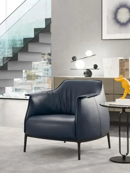 A high-class imported sofa chair in a deep blue leatherette, perfect for a sophisticated living room or a modern office reception area.