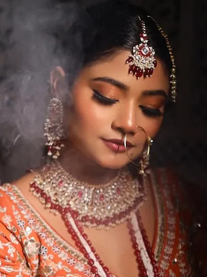 For this Nikkah look, I used a warm, peachy-gold glitter on the eyes to create a soft, ethereal glow. The smoke effect adds a touch of drama to the shot.