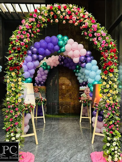 A full view of the grand floral and balloon entrance arch we created for Vani's first birthday. This impressive structure sets a spectacular tone for the celebration inside.