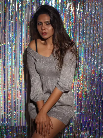 A more subdued, moody portrait against the shiny backdrop.