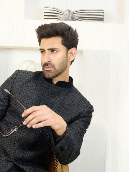 This angle of the black Jodhpuri suit emphasizes its sharp cut and how it sits perfectly on the shoulders. It’s a modern classic for the discerning man.