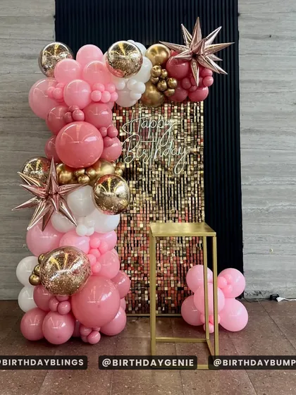 The full setup of the rose gold balloon column, complete with a plinth for a cake or gifts.
