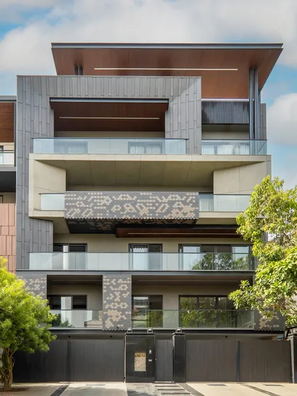 A full view of the Akashneem Marg project in DLF Phase-2, showcasing its simple, modern, and sustainable design. The facade's earthy tones of grey and metal create a perfect blend of form and function.