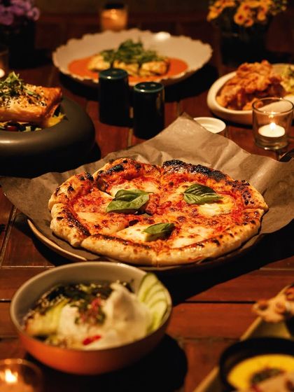 Our artisanal pizzas are a highlight of the evening menu, crafted with high-quality ingredients and baked to perfection.
