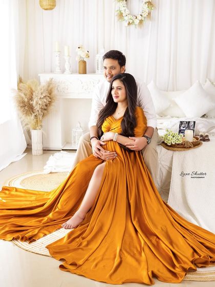 A glamorous and loving portrait of the couple on our studio bed set. The flowing golden gown adds a touch of luxury to this intimate scene.