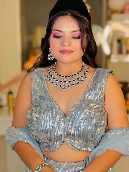 A close-up of the silver sequin blouse, showing the intricate pattern and the beautiful makeup look it pairs with.