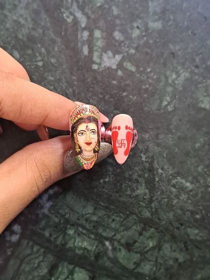Shubh Navratri! A close-up of my hand-painted Maa Durga portrait nail, paired with a nail featuring auspicious footprints.
