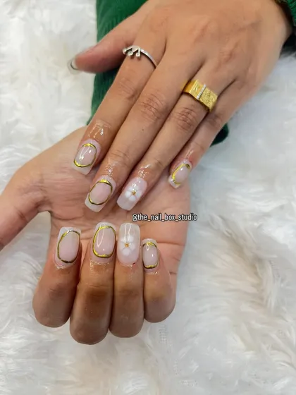 An elegant and modern design using gold chrome. I created a "frame" effect with the chrome around the edge of the nail and added a delicate 3D white flower as an accent.