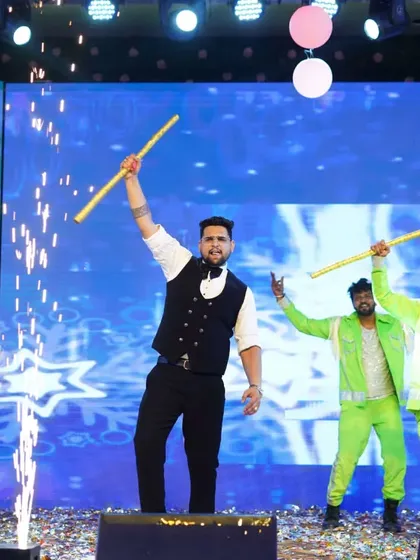 A powerful still from a groom's performance, using sticks as props for a folk-fusion dance number. We incorporate various elements to make each act unique and visually engaging.
