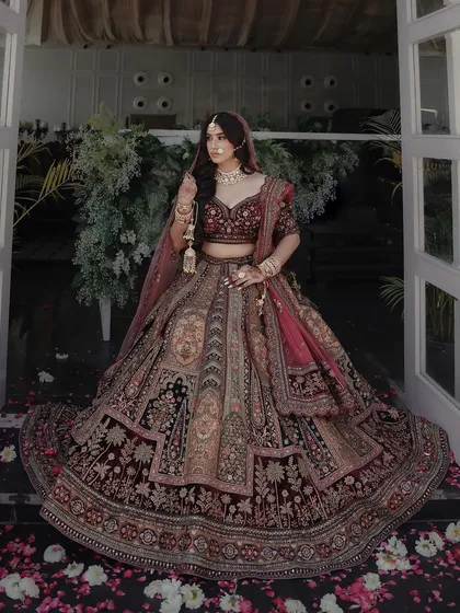 The complete vision. The rich, multi-layered lehenga is balanced with elegant makeup and a flowing hairstyle for a truly royal feel.
